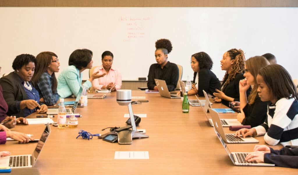 Anxious professional at board meeting - workplace confidence issues